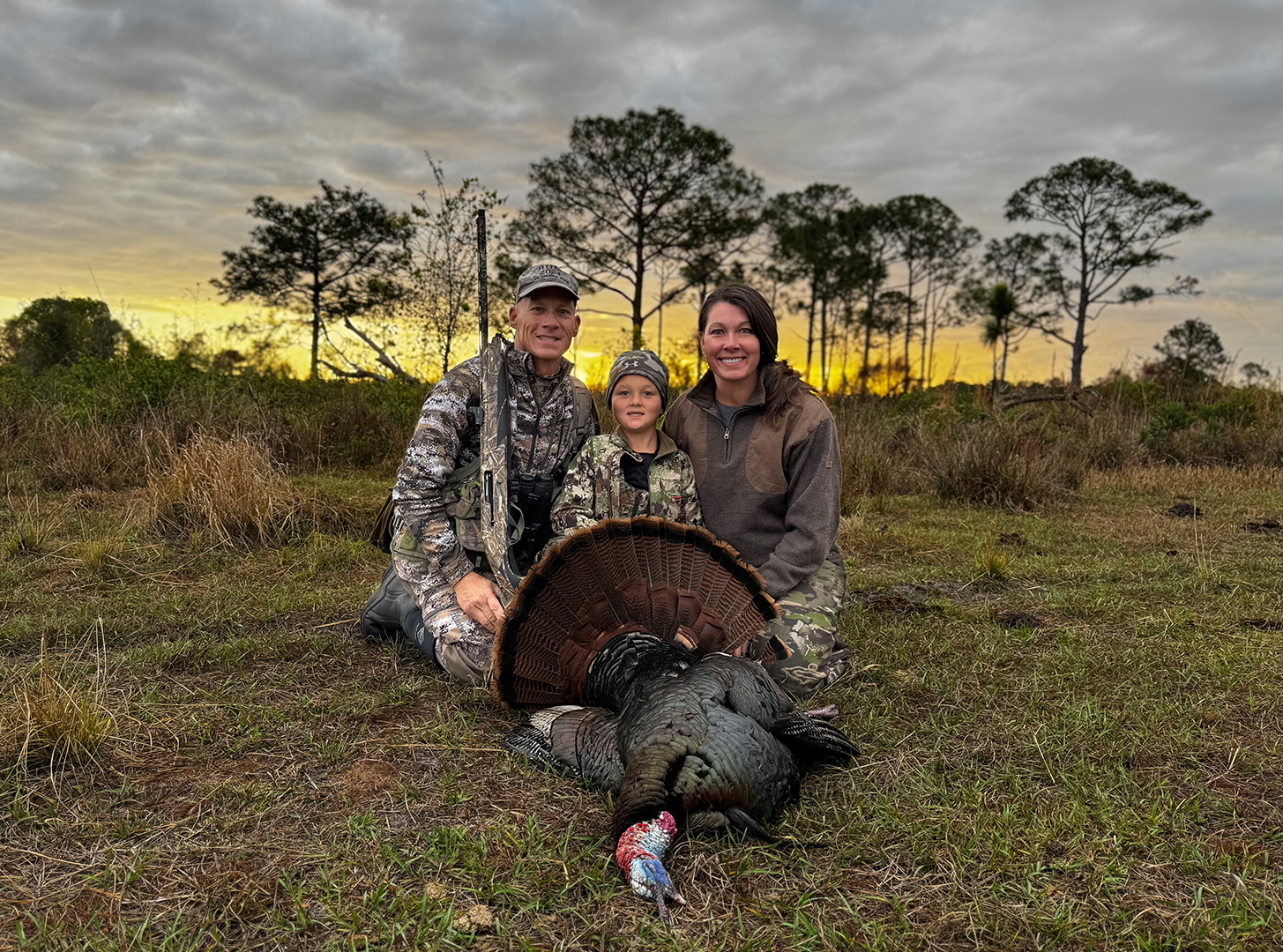 Osceola-with-Budz-Family Hunt Budz with his Osceola turkey and parents Jeff and Jenny Budz.